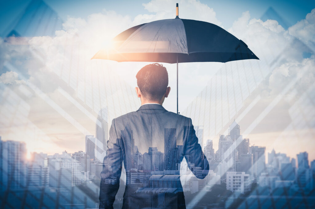businessman holding umbrella with back to us, business insurance concept